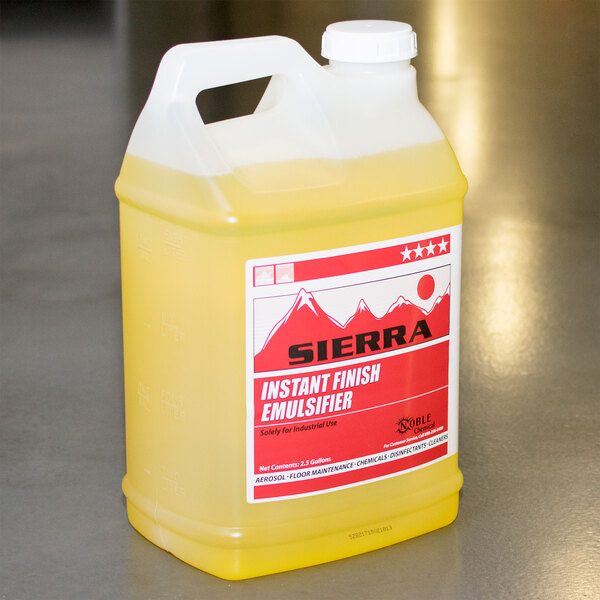 A 2.5 gallon container of yellow Sierra floor finish emulsifier on a counter.