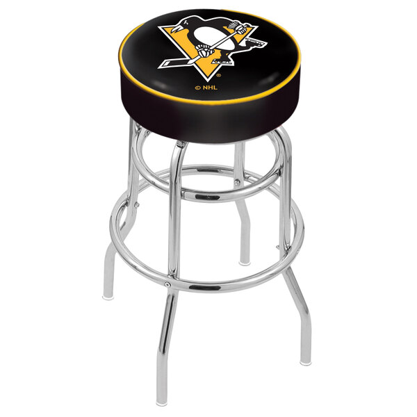 A black and yellow Holland Bar Stool Pittsburgh Penguins swivel bar stool with a hockey puck design on the seat.