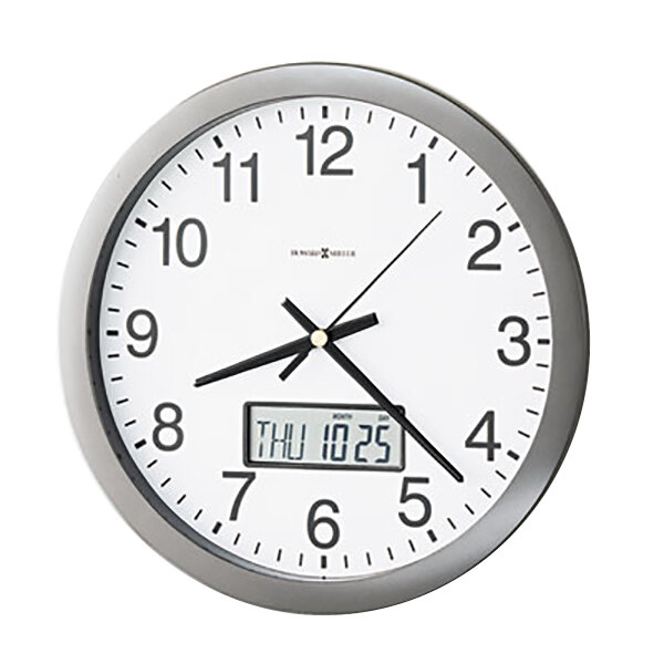 A gray Howard Miller wall clock with a white face and black numbers and a digital display.