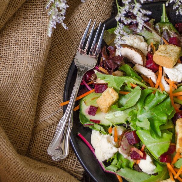 A salad with beets, carrots, and other vegetables served with a Walco Barony stainless steel salad fork.