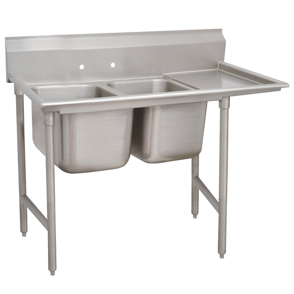 An Advance Tabco stainless steel two compartment pot sink with right drainboard.