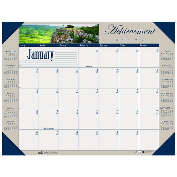 A House of Doolittle desk pad calendar with a picture of a mountain and trees on it.