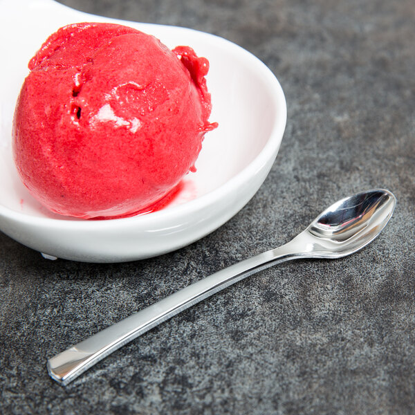 A white bowl of red ice cream with a Fineline silver plastic tasting spoon.