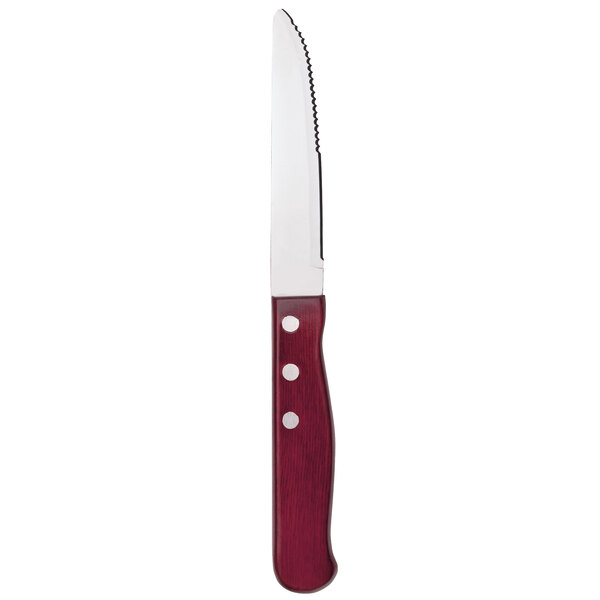 A Libbey steak knife with a red pakkawood handle and stainless steel blade.