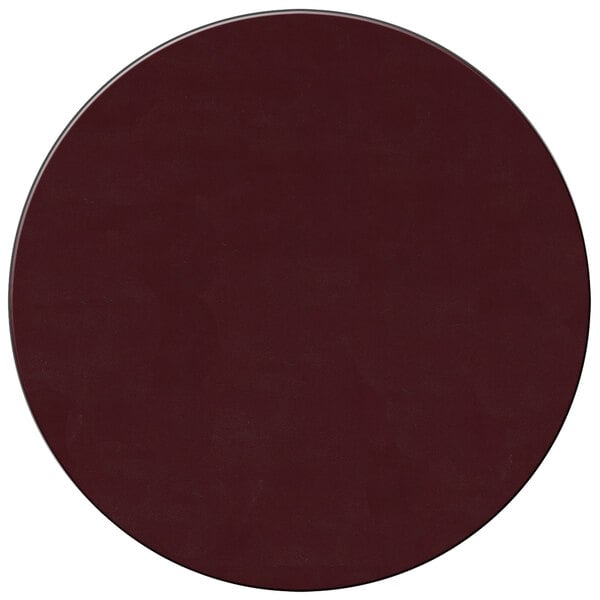 A dark red round vinyl placemat with white dots on a table.