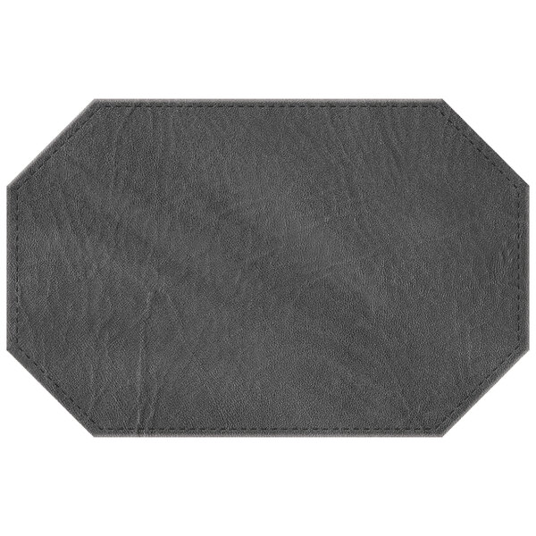 A charcoal faux leather octagon placemat with stitching.