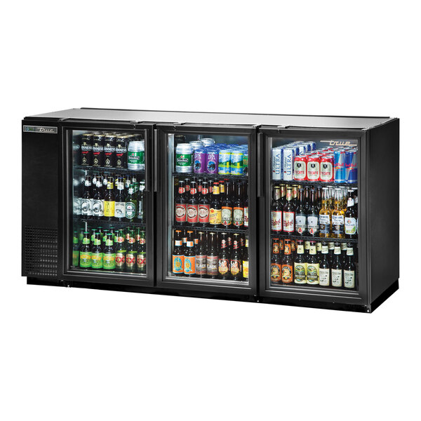 A black True back bar refrigerator with bottles of beer inside.