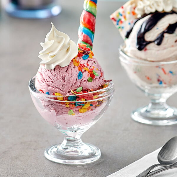 Two Acopa dessert dishes of ice cream with colorful sprinkles and candy sticks.