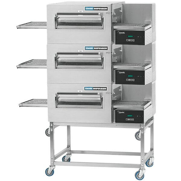 A Lincoln triple conveyor oven package with a stainless steel exterior.