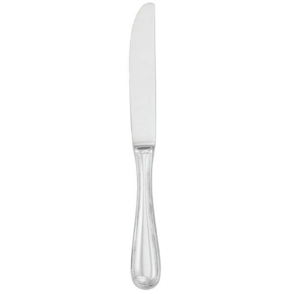 A Walco stainless steel dinner knife with a silver handle on a white background.