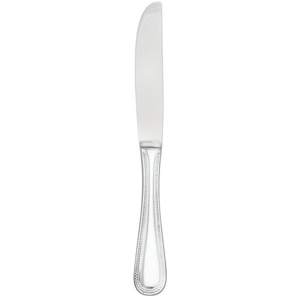 A silver Walco stainless steel butter knife with a white handle.