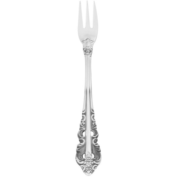 A silver Walco cocktail fork with a Baroque design.