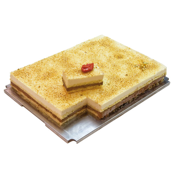 A close-up of a rectangular cake with a slice of cheese on top.