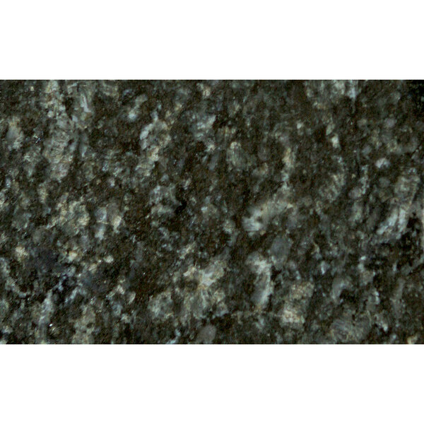 A close-up of an Uba Tuba granite tabletop with black and white speckles.
