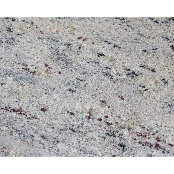 A close up of a Kashmir White granite table top.