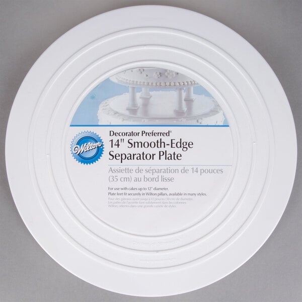 A white plastic Wilton cake separator plate with a label on it.