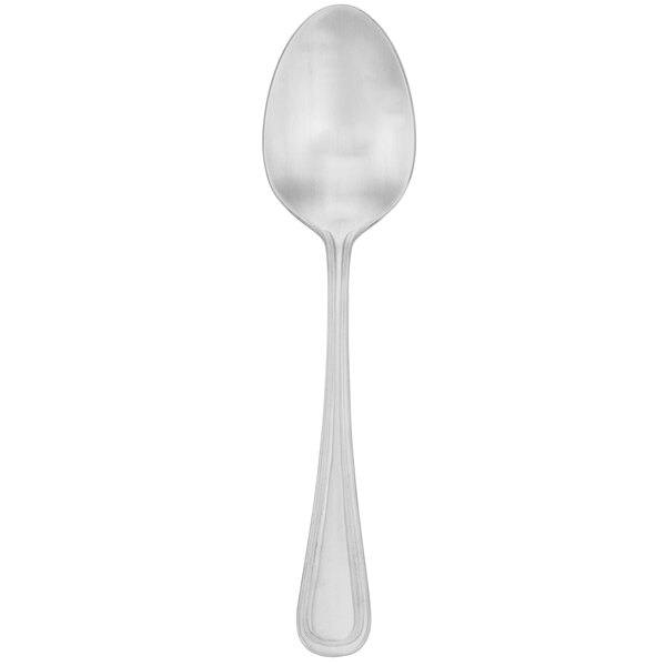A silver Walco Napa stainless steel serving spoon with a white handle.