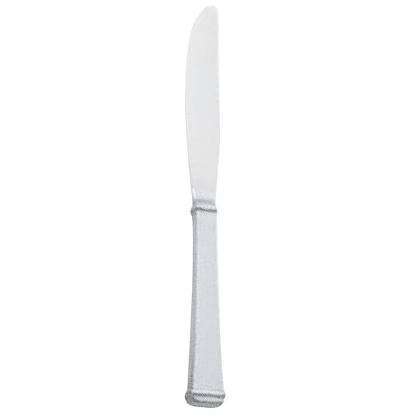 A Walco Farmington stainless steel table knife with a white handle.