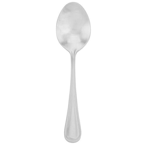 A Walco stainless steel teaspoon with a silver handle.