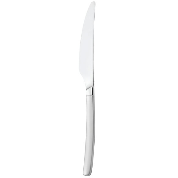A close-up of a Walco stainless steel table knife with a white handle.