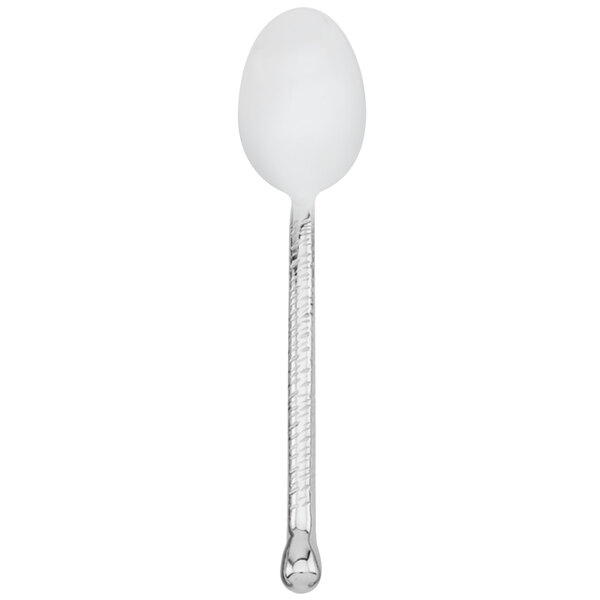 A Walco stainless steel dessert spoon with a hammered metal handle.