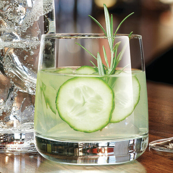 A Chef & Sommelier Sequence double old fashioned glass with cucumber slices in it.