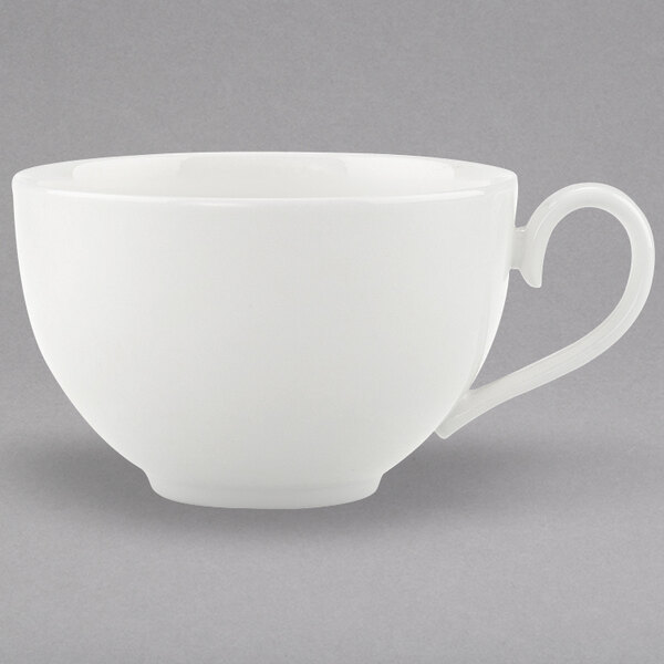 A close-up of a white Villeroy & Boch bone porcelain cup with a handle.