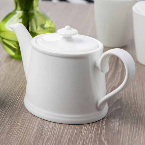 A white Villeroy & Boch teapot on a table.