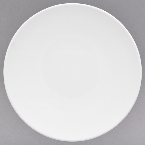 A Villeroy & Boch white porcelain plate with a white rim on a gray surface.