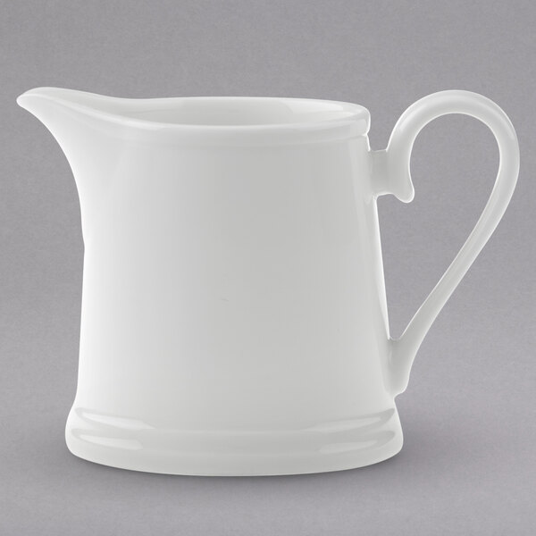 A white Villeroy & Boch porcelain creamer with a handle.