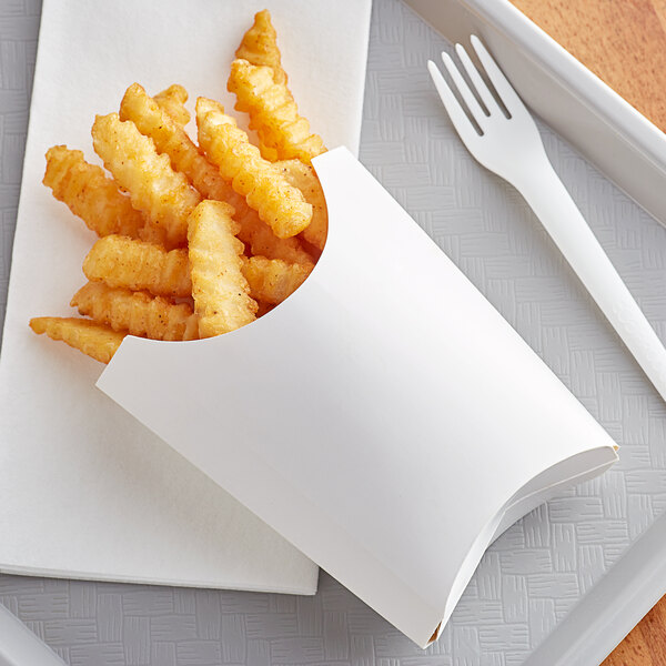 A white paper tray with french fries on it.
