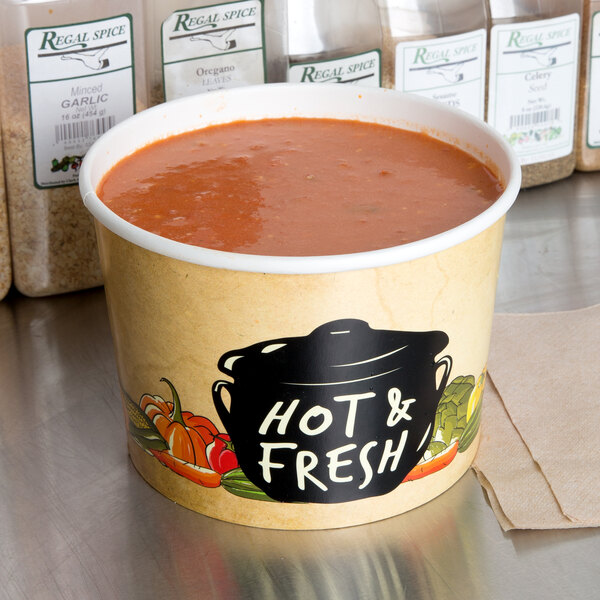 A Choice paper soup container filled with soup on a counter.