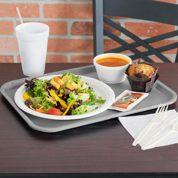 A Vollrath fast food tray with a salad, cup of soup, and a fork on a table.