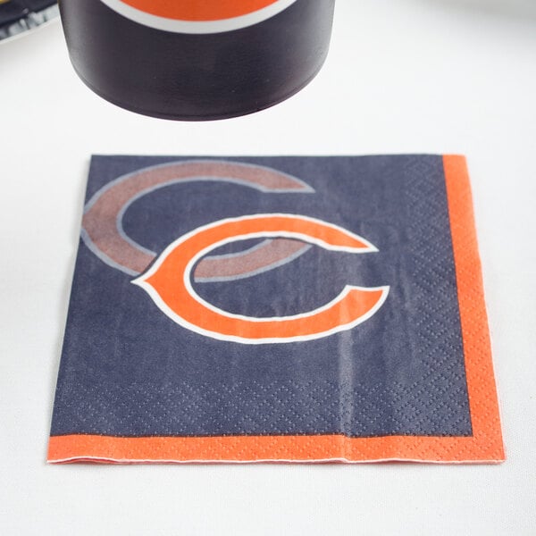 A Chicago Bears beverage napkin with the team's logo in black and orange.