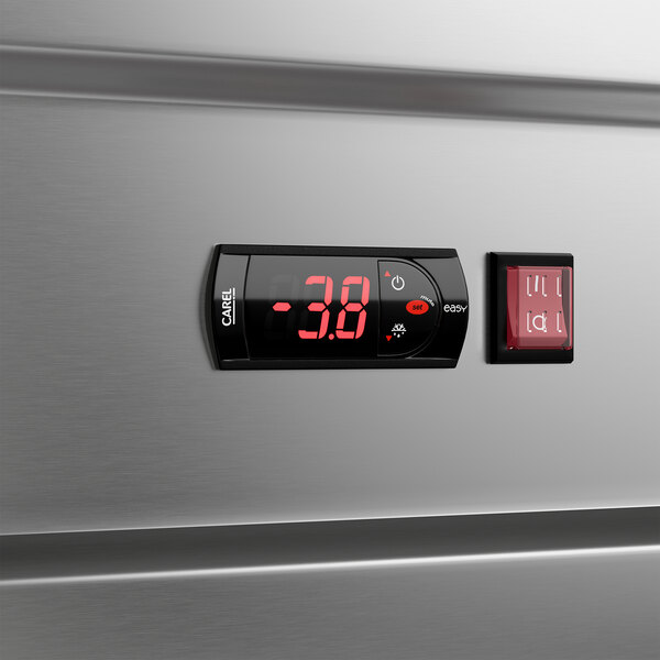 A stainless steel reach-in freezer with a digital temperature display and control panel.