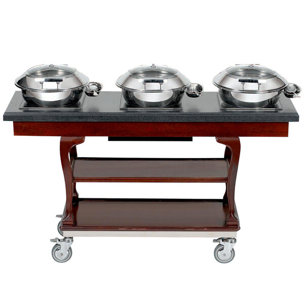 A Bon Chef mobile wood induction buffet table with a row of silver pots on top.