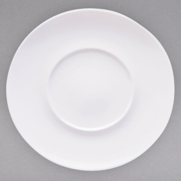 A close-up of a Villeroy & Boch white porcelain flat plate with a well and a white rim.