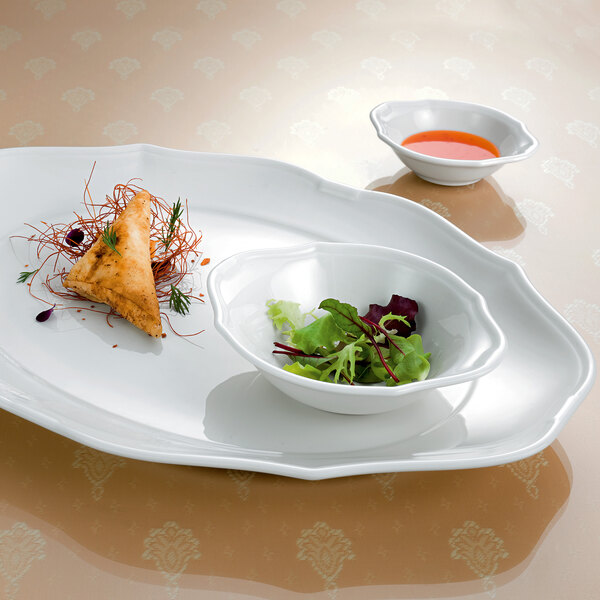 A white Villeroy & Boch porcelain oval bowl with food in it.