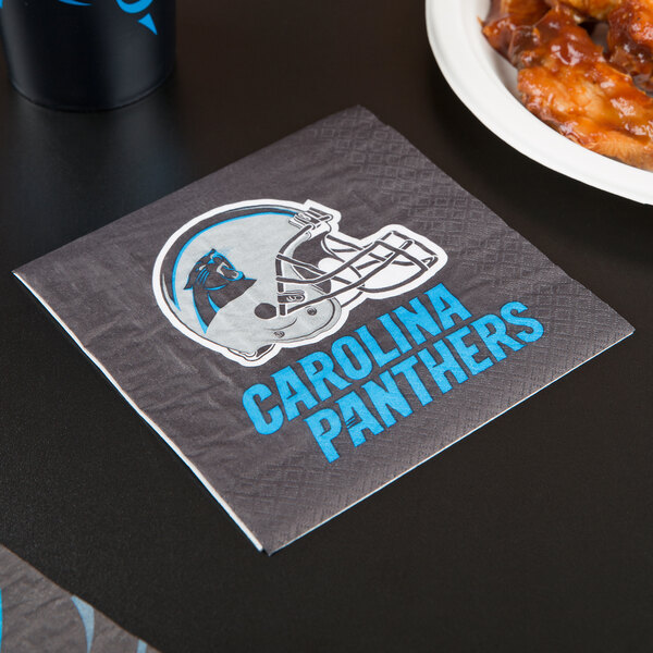 A Carolina Panthers luncheon napkin on a table.