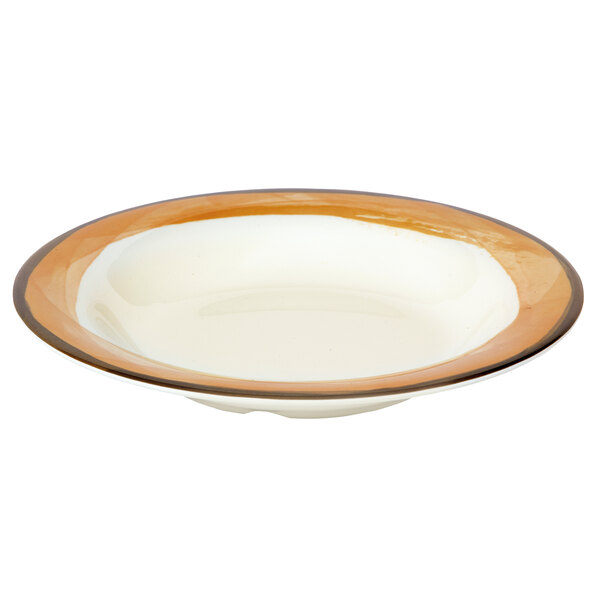 A close up of a GET Diamond Ivory melamine bowl with a brown and orange rim.