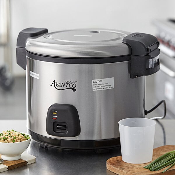 An Avantco electric rice cooker with rice and peas in a bowl on a counter.