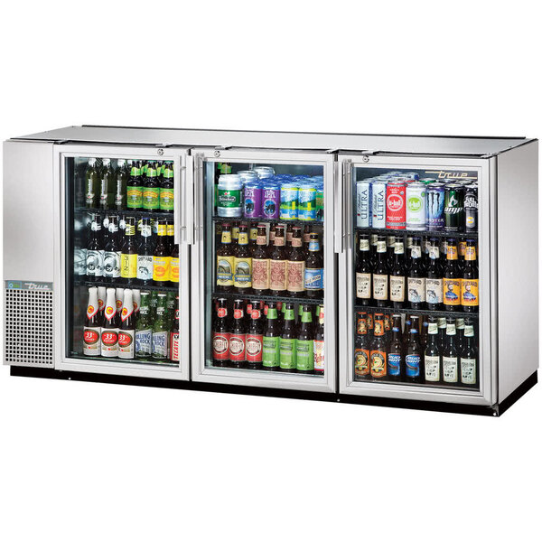 A True back bar refrigerator with glass doors full of beer and beverages.
