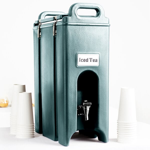 A slate blue Cambro Camtainer tea dispenser with a metal lid.
