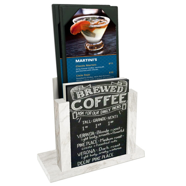 A Menu Solutions white wash wood menu holder with a chalkboard insert displaying a drink on a counter.