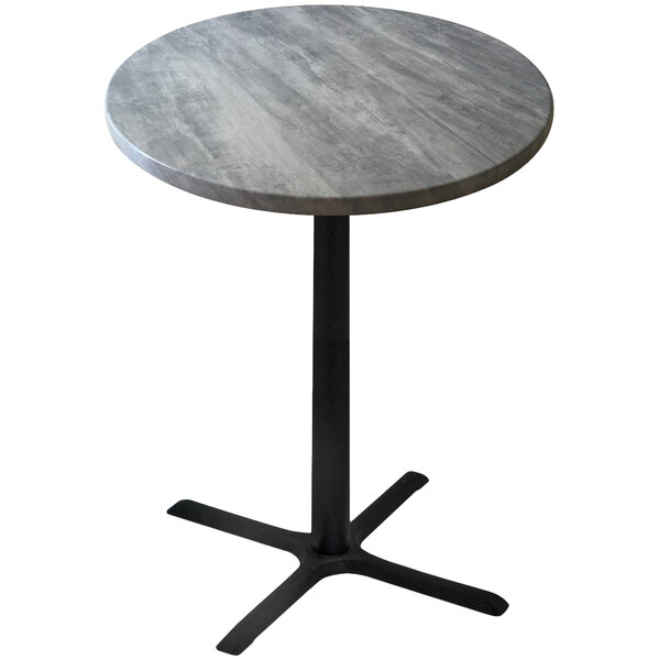 A round table with a metal base and a greystone top.