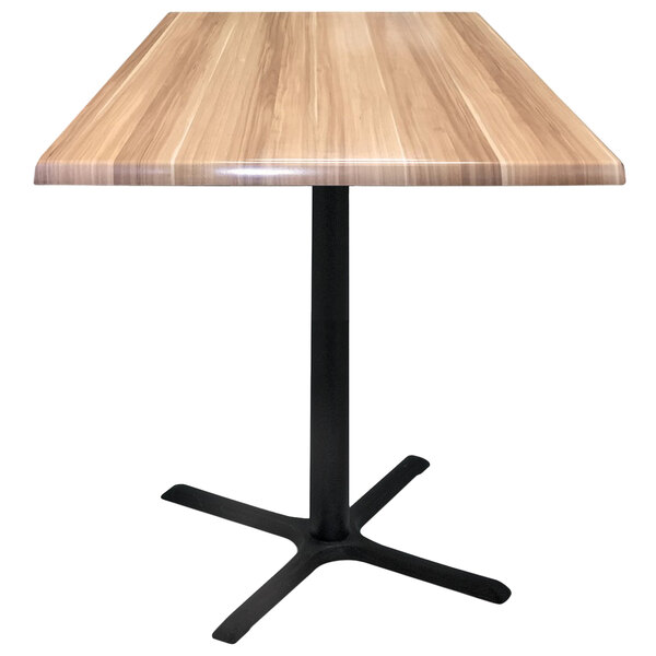 A Holland Bar Stool natural wood table top on a black cross base.