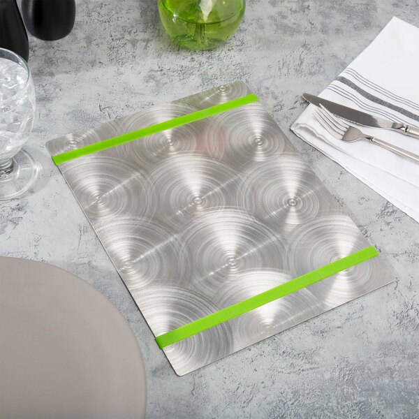 A table set with Menu Solutions Alumitique menu boards on silver plates with green bands.