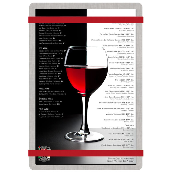 A Menu Solutions customizable brushed aluminum menu board with red bands on a table with a glass of wine.