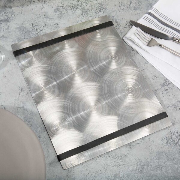 A customizable Alumitique menu board with black bands on a table with silverware and a white napkin.