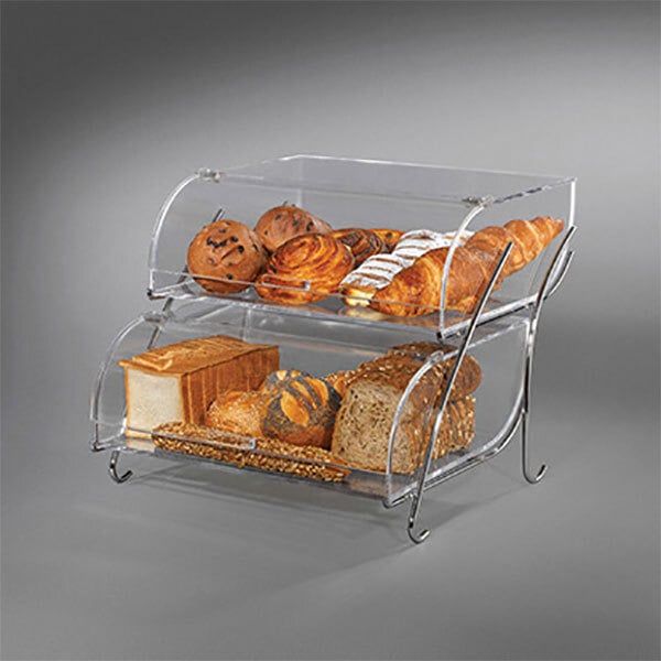 A clear acrylic bakery display case with bread and pastries on two tiers.